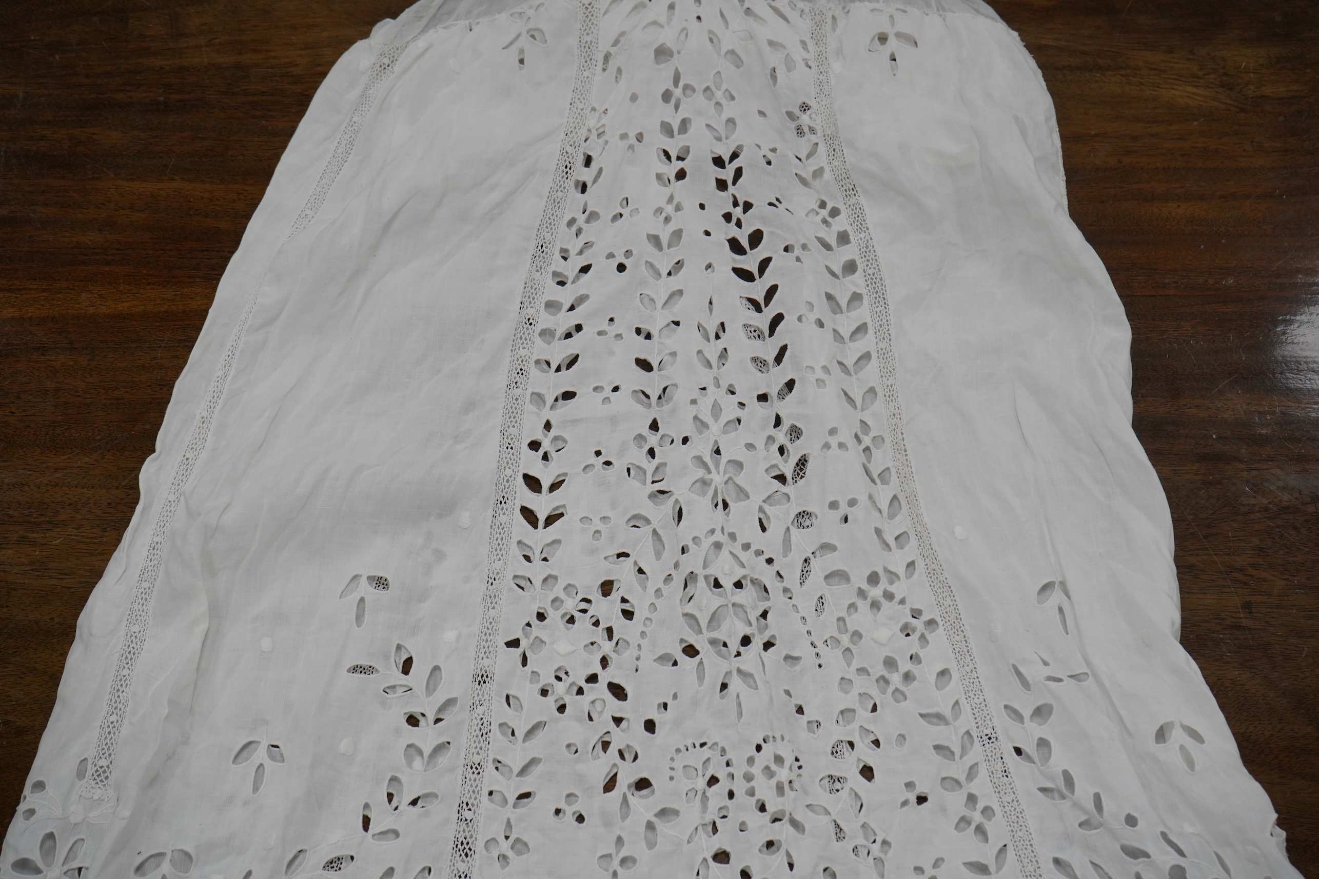 An Edwardian fine white embroidery anglaise and Irish crochet trimmed ladies summer dress, designed with large panels of anglaise cut work, the dress has been altered and restyled, which could be altered back, 134cm long